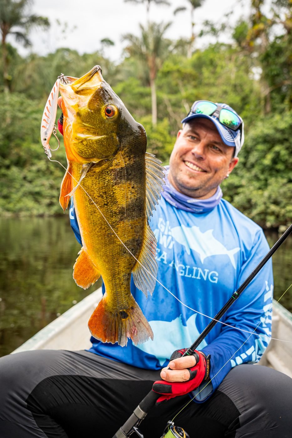 Angler with a peacock bass