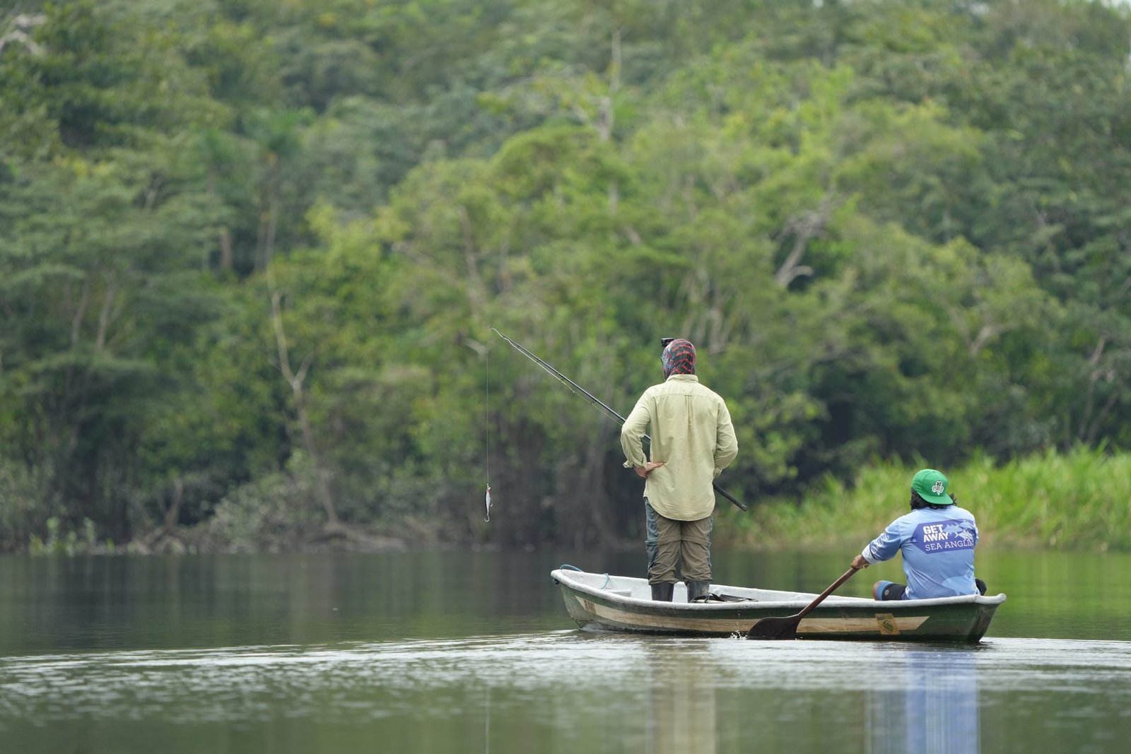 Angler and guide fishing from the canoe